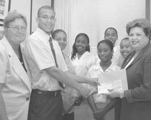 JGR receive a cheque for CI$5,000 from Mrs Basdeo